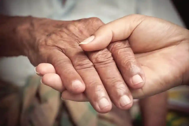 holding hands with a caregiver, caregiver tips for aging parents at home